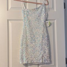 a white dress hanging on a door hanger