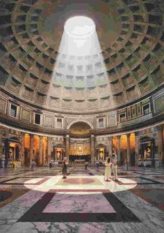 the inside of a large building with people walking around and looking up at the ceiling