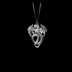 Unleash your inner fire with our Dragon pendant. Crafted with exquisite detail, this powerful piece embodies the untamed strength and mystique of the dragon, a symbol of wisdom and fierce protection. Feel the energy of this ancient guardian as it wraps you in its embrace, reminding you of your own unyielding spirit and the burning passion within. PENDANT INFORMATIONThis pendant is made of real, solid gold.• Made in USA• Material: 14k or 18k solid gold• Finish: polished• Height: 1.3" (33 mm) x Wi Fantasy Style Engraved Pendant Necklace, Mystical Engraved Pendant Jewelry, Fantasy Silver Jewelry With Dragon Design, Silver Fantasy Jewelry With Dragon Design, Fantasy Dragon Design Necklace, Collectible Fantasy Jewelry With Dragon Design, Fantasy Dragon Design Jewelry For Collectors, Dragon Design Amulet Jewelry As Gift, Symbolic Dragon Design Round Pendant Necklace