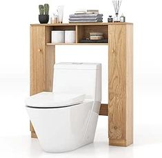 a white toilet sitting next to a wooden shelf