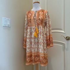 Nwt Made With Boho Dress Is A Pretty Floral Pattern Of Golds, Olive And Wine . Double Tie Front With Tassels. New With Tag . See Close Up Photos For Colors And Details Yellow Flowy Dress With Boho Print, Flowy Yellow Dress With Boho Print, Flowy Yellow Boho Print Dress, Casual Yellow Boho Print Dress, Yellow Long Sleeve Dress With Boho Print, Orange Long Sleeve Boho Dress With Print, Long Sleeve Yellow Dress With Boho Print, Yellow Long Sleeve Boho Print Dress, Summer Long Sleeve Orange Boho Dress