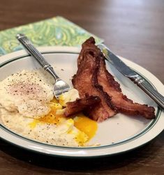 a plate with eggs and bacon on it