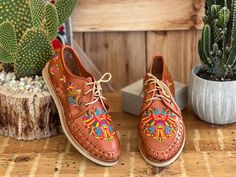 Let your shoes be the star of the show when you wear these beautiful Artisanal Mexican Shoes! These premium quality shoes are made from Mexican leather, feature beautiful multicolor traditional embroidered design and has laces for an adjustable fit. These are the highest quality in Artisanal leather shoes. They are completely made by hand, making them one of a kind! How to order your size: Example, If you wear a size 7.5 order a 7. If you are a size 7 order a 7. The sandal will mold to your feet Casual Embroidered Huarache Sandals For Festival, Traditional Hand Tooled Huaraches For Spring, Embroidered Leather Huarache Sandals For Festival, Leather Embroidered Huarache Sandals For Festivals, Traditional Embroidered Leather Huarache Sandals, Traditional Handmade Multicolor Huaraches, Traditional Multicolor Slip-on Huaraches, Traditional Leather Huaraches For Fiesta, Traditional Multicolor Leather Huaraches