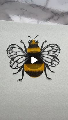 a drawing of a bee on top of a piece of paper