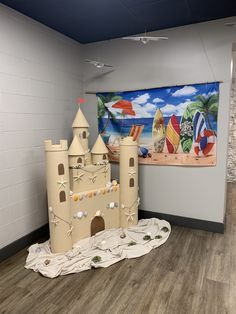 a castle made out of cardboard sitting on top of a floor next to a wall