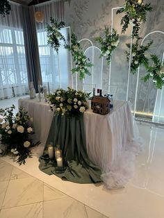 the table is set up with candles and greenery for an elegant wedding ceremony at the hotel