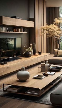 a living room filled with furniture and a flat screen tv on top of a wooden table