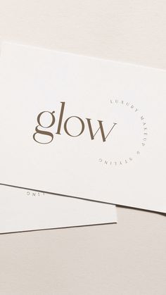 two business cards with the word glow printed on them