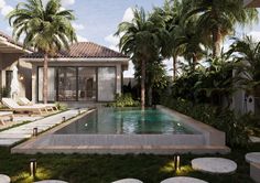 a pool surrounded by palm trees next to a house with a swimming pool in the middle