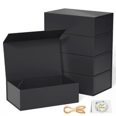 two black boxes with gold handles, one open and the other closed next to each other