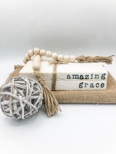 two books and a ball of string on top of each other with the words amazing grace written on them