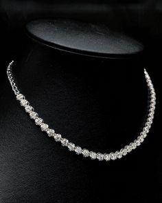 She'll never tire of wearing this classic and sophisticated diamond tennis necklace. Stunning in 18K solid white gold, this breathtaking line of shimmering round diamonds. So elegant, this 16.0-inch diamond necklace will take her breath away. Radiant with 4.90 cts. t.w. of diamonds and buffed to a brilliant luster, this glamorous keepsake secures with a box clasp. The setting design make the diamonds look much bigger than they are. When worn, the diamonds look like 1/2 carat each. Diamonds Detai Silver Single Strand Tennis Necklace For Anniversary, Wedding Silver Tennis Necklace With Prong Setting, Silver Prong Set Tennis Necklace For Wedding, Silver Tennis Necklace With Prong Setting For Wedding, Wedding Solitaire Necklace Silver Single Strand, Silver Solitaire Single Strand Necklace For Wedding, Diamond White Single Strand Solitaire Necklace For Anniversary, Silver Tennis Necklace With Single Cut Diamonds For Wedding, Wedding Tennis Necklace In White Gold With Round Cut