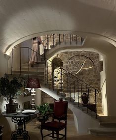 a living room filled with furniture and a spiral staircase