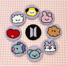 a group of small buttons with different designs on them in the shape of animals and letters