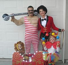 two people dressed up as clowns and a man in a circus costume standing next to each other