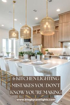 a kitchen island with chairs and lights hanging from it's ceiling over the counter