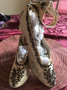 "These fabulous antique silk beaded wedding shoes are the most unique examples of footwear from the latter part of the 1800s. They are crafted with luscious silk uppers adorned with teeny copper-colored beaded designs. They also have beaded silk ankle straps that close with matching covered buttons. The numbers 37 and 4 are stamped on the soles and some writing in ink that includes \"1865\". These lovely works of art are in great condition for their 130+ years with only a couple of small splits, Celestial Witch, Beaded Flapper Dress, Beaded Designs, Satin Wedding Gown, Dog Bones, Wedding Shawl, Beaded Wedding, Womens Wedding Shoes, Silk Wedding