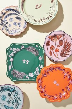 four plates with different designs on them sitting next to each other in the same pattern