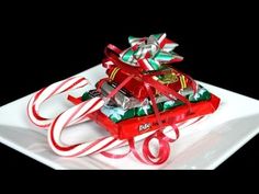 a white plate topped with candy canes and wrapped presents