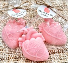 three pink heart shaped soaps with thank you for coming tags on the front and back