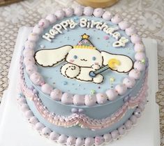 a blue birthday cake with an elephant on it