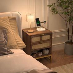 a bedroom with a bed, night stand and potted plant on the side table