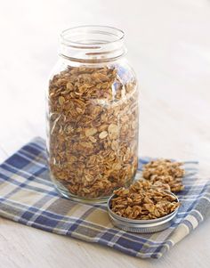 a glass jar filled with granola sitting on top of a blue and white towel