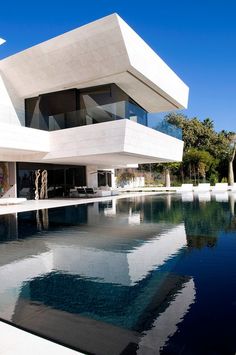 a large white building sitting next to a swimming pool