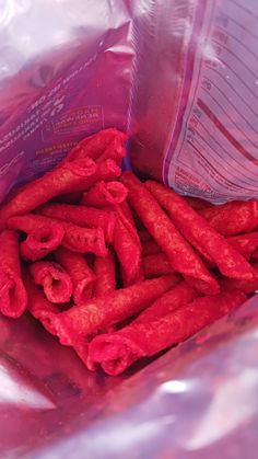 there are some red food sticks in the bag