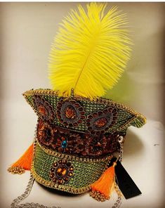 This is a stunning green captain hat. It is enriched with lots of detail , gems , tassels , vibrant yellow feather to name a few. This is a hand crafted hat in a size 59cm which fits most heads.  Please note any traces of glue is not a defect but characteristics of a hand created item. No two hats are created the same so this is an individual item. Thank you for looking Traditional Costume Hats And Headpieces For Carnival, Traditional Carnival Costume Hats And Headpieces For Party, Traditional Carnival Costume Headpieces, Bohemian Mardi Gras Party Costume Headpiece, Bohemian Mardi Gras Party Headpiece, Bohemian Mardi Gras Party Hat, Bohemian Crown Costume Hat For Carnival, Bohemian Costume Hats And Headpieces For Festival Party, Bohemian Crown For Carnival