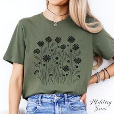 Boho Flower Unisex Tee Shirt | Black Wildflower Tshirt | Cottagecore Tee | Nature Tee | Floral Clothing ✔️ Soft, light and comfortable unisex short sleeve tee ✔️ 100% Airlume combed and ringspun cotton (fiber content may vary for different colours*) ✔️ Light fabric (4.2 oz/yd² (142 g/m ✔️ Retail fit 📏 Runs true to size ✔️ Dual side seams for structural support of the garment help hold its shape longer ✔️ Ribbed knit elastic collars to bolster shaping, twill taped shoulders to prevent stretching Black Floral Print Casual T-shirt, Black Short Sleeve Shirt With Plant Print, Black Crew Neck T-shirt With Plant Print, Black Graphic Tee With Plant Print, Black Floral Print Crew Neck Tops, Black Graphic Tee With Plants Print, Casual Black T-shirt With Plant Print, Black Graphic Tee With Floral Print, Black Floral Print Graphic Tee Shirt