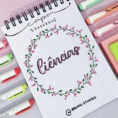 a spiral notebook with the word creacias written in cursive writing