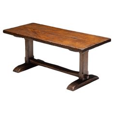 an old wooden table with two legs and a wood slab on the top, against a white background