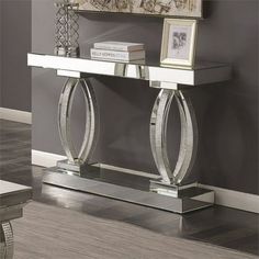 an elegant console table with mirrored top and silver accents, in a living room setting