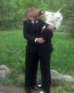 two men in suits are kissing and one is wearing a dog's head on his shoulders