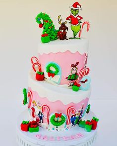 a three tiered cake decorated with candy canes and dr seusselu characters