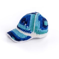 a blue and white crocheted hat on a white background