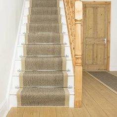 the stairs are made of wood and have metal handrails on them, along with carpeted flooring