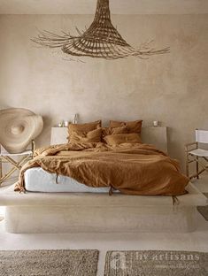 a bedroom with a large bed, wicker chair and rattan lamps hanging from the ceiling