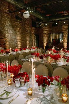 the tables are set with candles and flowers