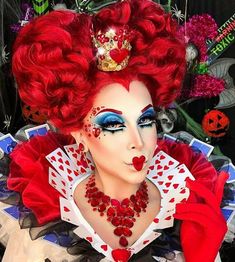 a woman with red hair and makeup is dressed as a queen of hearts