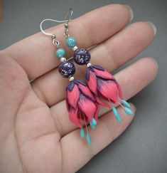 Long, but lightweight floral dangle earrings are made of polymer clay in vivid fuchsia pink, purple and teal colors. These beautiful flowers are so romantic and full of joy, they make me smile just looking on them. The earrings will be a great jewelry gift for every woman.The ear hooks are made of stainless steel (hypoallergenic, lead and nickel free).Dimensions: 2 1/2 inches from top of ear wire, width 1/2 inchesCan be made in different sizes and colors - please feel free to ask me about the cu Pink Polymer Clay Jewelry With Ear Wire, Pink Handmade Flower Polymer Clay Earrings, Handmade Pink Flower Earrings In Polymer Clay, Pink Flower Shaped Polymer Clay Earrings, Pink Flower-shaped Polymer Clay Earrings, Handmade Pink Polymer Clay Flower Earrings, Pink Polymer Clay Flower Earrings, Fantasy Pendant, Flower Dangle Earrings