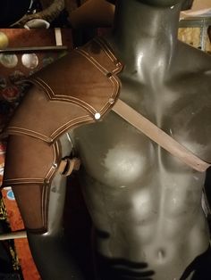 a mannequin wearing a leather harness in a shop