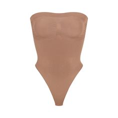 Cinch your waist and sculpt your tummy and core in this perfectly compressive strapless thong bodysuit. Wear it your way with removable adjustable straps that convert to shoulder straps, cross-back, or halter-style. Features center front and side stitching to define and support your bust, and a cotton gusset with snap closure. Fits true to size. | SKIMS Strapless Thong Bodysuit | Medium Neutral | Seamless Sculpt Strapless Shaping Bodysuit With Built-in Bra, High Cut Nylon Bodysuit With Built-in Bra, Solid Strapless Smoothing Bodysuit, Strapless Nylon Tube Top With Built-in Bra, Seamless Stretch Tube Top, Strapless Smoothing Bodysuit Shapewear, Strapless Stretch Shapewear Bodysuit, Strapless Smoothing Shapewear Bodysuit, Strapless Shapewear Bodysuit With Lined Body