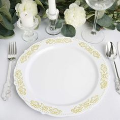 a white and gold place setting with silverware