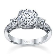 an engagement ring with three stones on the side and two diamonds in the middle,