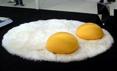 two eggs sitting on top of a white rug