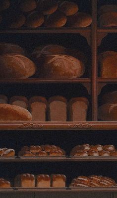 breads and rolls are on display in a bakery