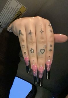 a woman's hand with tattoos on it