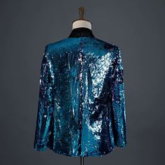 a blue sequin jacket on a mannequin stand with the back turned to show it's shiny fabric